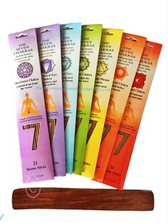 seven chakras are lined up next to each other on top of a wooden stick