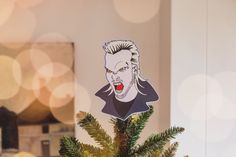 a christmas tree with a sticker of the character marilyn monroe on it's head