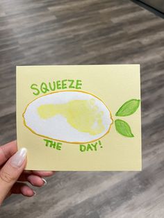 someone holding up a piece of paper with the words squeeze the day written on it