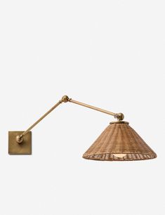 a wall light with a bamboo shade on the side and a metal rod attached to it