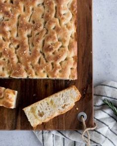 a loaf of sourdough focaccia on a cutting board