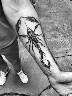 a man's arm with a black spider tattoo on it