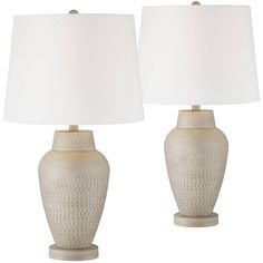 two white ceramic lamps with shades on them