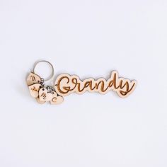 a wooden keychain with the word granny written in cursive writing on it