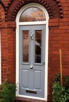 a blue front door on a brick building