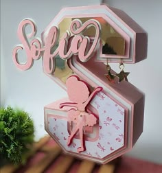 a pink birthday card with the word sofira on it and a heart shaped box