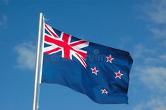 an australian flag flying in the blue sky