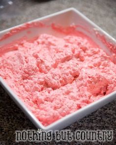 a white bowl filled with pink food on top of a counter