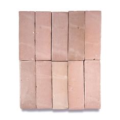 several blocks of pink clay sitting on top of each other