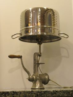 an old fashioned tea kettle sitting on top of a stove