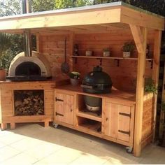 an outdoor kitchen made out of wood with pots and pans