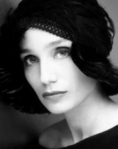 a black and white photo of a woman wearing a hat