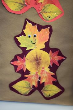 fall leaves cut out to look like a person's face and the word p