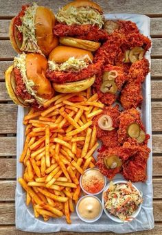 a tray filled with lots of different types of food on top of a wooden table