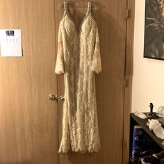 a white dress hanging on a door