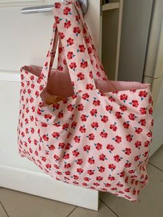 "Welcome to my shop! This eco friendly Hobo is handmade with imported designer cotton fabric and has a gorgeous  floral print. The matching pink lining  and the handles are  made from pure homespun cotton. The Hobo bag is light as a feather  and fits into handbags. size:  Width: 20\" Height: 14\" Handle drop\" 6\" Cool wash on gentle cycle Wonderful gift idea! All my hobos are lovingly  made individually and  are not a mass production." Pink Cotton Bag For Summer, Pink Fabric Bags For Summer, Pink Cotton Bags For Summer, Cute Cotton Bags For Spring, Pink Cotton Bags For Spring, Pink Floral Print Bags For Summer, Summer Pink Floral Print Bags, Summer Cotton Bag With Floral Print, Everyday Pink Fabric Bags