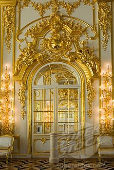 an ornately decorated room with gold trimming and chandeliers on the walls