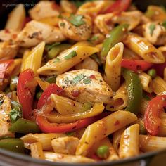 pasta with chicken and peppers in a skillet