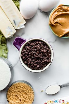 ingredients to make chocolate chip cookies laid out on a table