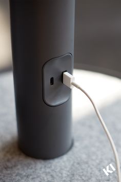 an electrical outlet plugged into a gray cup