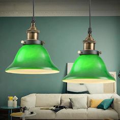 two green lights hanging over a white couch