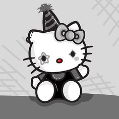 a hello kitty sitting on the ground with a party hat on top of it's head