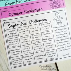 the october challenge is on top of a wooden table with pink and blue papers in it