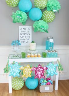 a table topped with lots of blue and green decorations