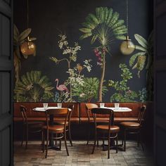 the interior of a restaurant with tropical wallpaper and wooden tables, chairs, and lamps