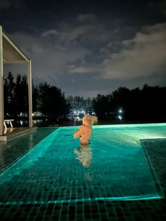 a person in a swimming pool at night