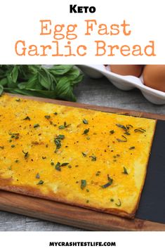 keto egg fast garlic bread on a cutting board with eggs in the background and text overlay