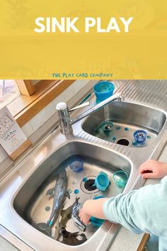 a little boy playing with some water in a sink