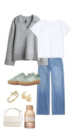 a woman in grey sweater, jeans and sneakers