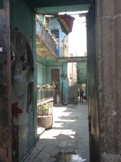 an alley way with people walking down it