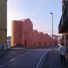 a person walking down the street in front of some buildings