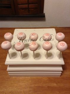 pink cake pops sitting on top of a table