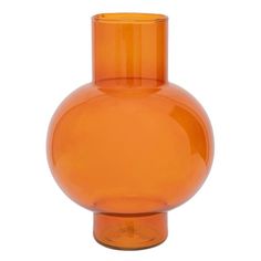 an orange glass vase sitting on top of a white table