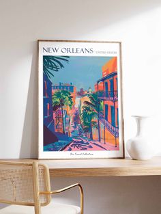 a framed new orleans travel poster hangs on the wall next to a chair and table