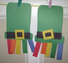 two christmas stockings hanging on a clothes line with paper clips attached to the front door