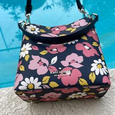 Kate Spade Darcy Small Bucket Bag Road Trip Floral Blue Multi Color: Floral Blue Multi 8.12"H X 7.87"W X 4.37"D Handle Drop: 6" Strap Drop: 19" Textured Pvc Metal Pinmount Logo Unlined Interior: Back Slip Pocket Exterior: Back Slip Pocket Magnetic Snap Closure Dust Bag Not Included Imported Style #K6111 Multicolor Rectangular Shoulder Bag By Kate Spade, Chic Multicolor Kate Spade Shoulder Bag, Pink Kate Spade Party Bag, Elegant Multicolor Kate Spade Bag, Luxury Multicolor Kate Spade Bags, Spring Floral Print Double Handle Bags, Kate Spade Multicolor Spring Bags, Kate Spade Travel Bag With Floral Print, Red Kate Spade Purse