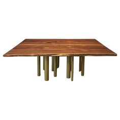 a wooden table with four metal legs