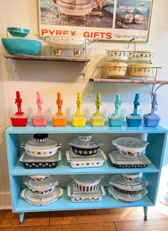 a blue shelf with bowls and plates on it