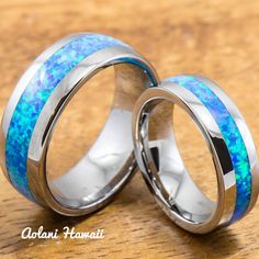 two wedding rings with blue opal inlays