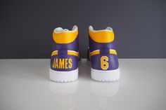 Custom Air Jordan 1 to represent your favourite team or player (Kobe Bryant & LeBron James pairs pictured) - Features player's name and number on Jordan 1 heel tab - Jordan 1, Low or Mid available - You choose your favourite team and/or player - Message me for mockup to finalise design Custom Air Jordan 1, Kobe Bryant Lebron James, Custom Jordans, Team Player, Cool Lego, Jordan 1 Low, Kobe Bryant, Lebron James, Sneakers Athletic