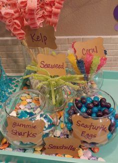 a table topped with lots of candy and candies on top of a blue tray