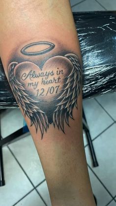 an angel tattoo with the words always in my heart and an angel on it's arm