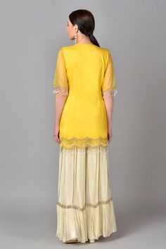 Yellow kurta with floral embroidered motifs and tassel sleeves. Paired with palazzo and scallop dupatta.
Component: 3
Embroidered
Neckline: V neck
Sleeve Length: Elbow
Fabric: Organza, Georgette, Silk, Net
Color: Yellow
Tassel sleeves - Aza Fashions Elegant Palazzo Set With Tassels, Elegant Festive Palazzo Set With Tassels, Elegant Eid Sets With Tassels, Georgette Sets With Tassels In Traditional Drape Style, Designer Elegant Sharara With Tassels, Elegant Designer Wear Sharara With Tassels, Elegant Sets With Tassels For Diwali, Festive Straight Kurta Sharara With Tassels, Festive Sharara With Tassels And Straight Kurta