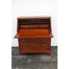 an old fashioned wooden desk with drawers