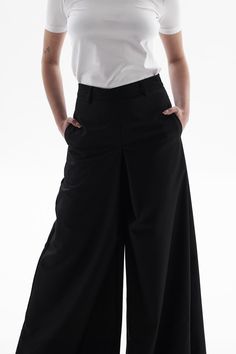 These pants are very versatile, perfect for both sneakers and heels. They are made from a dense poly-viscose fabric, with side seam pockets and a hidden zipper at the back. Modern Pants With Pockets In Elastane, Modern Elastane Bottoms With Pockets, Modern Elastane Pants With Pockets, Stretch Culottes For Workwear, Modern Wide-leg Pants With Welt Pockets, Stretch Culottes For Workwear, Ankle-length, Stretch Workwear Culottes, Ankle-length, Stretch Ankle-length Culottes For Work, Stretch Wide-leg Pants With Welt Pockets