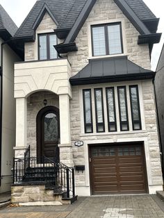 a large house with two garages on the front and one entrance to the back